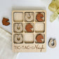 a wooden tic - tac - nich game with wooden pieces in it