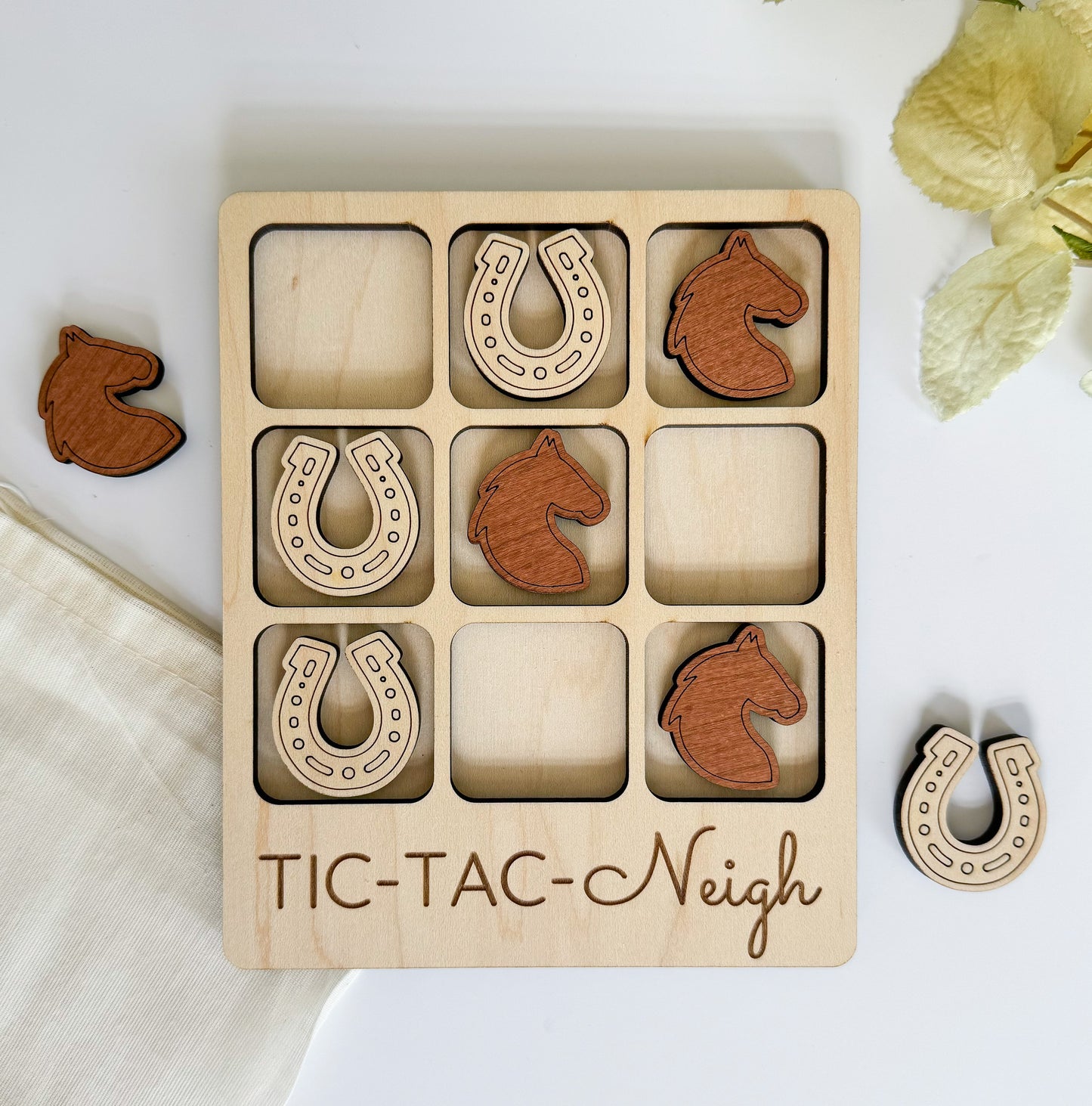 a wooden tic - tac - nich game with wooden pieces in it