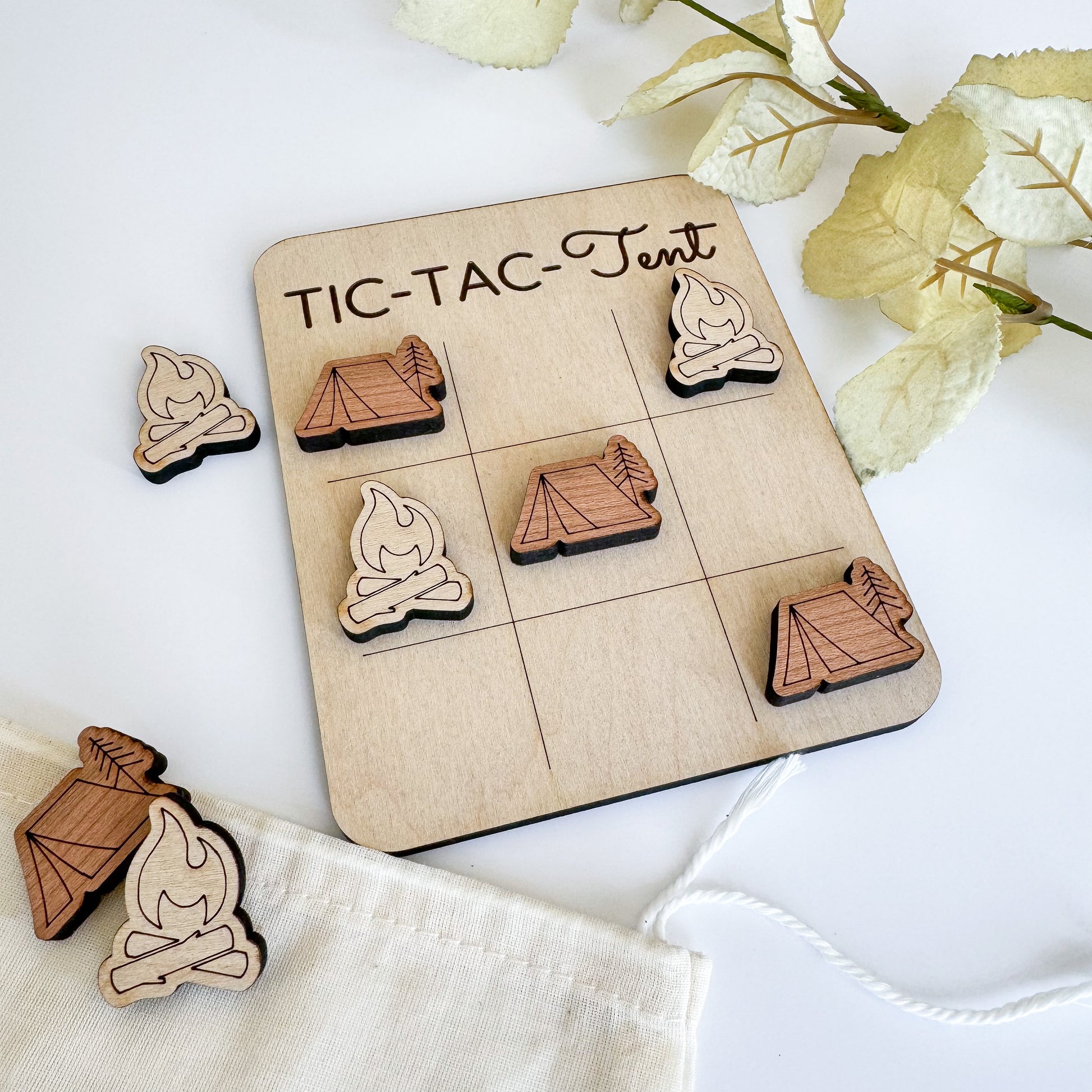 a wooden tic - tac - toe board with wooden pieces on it