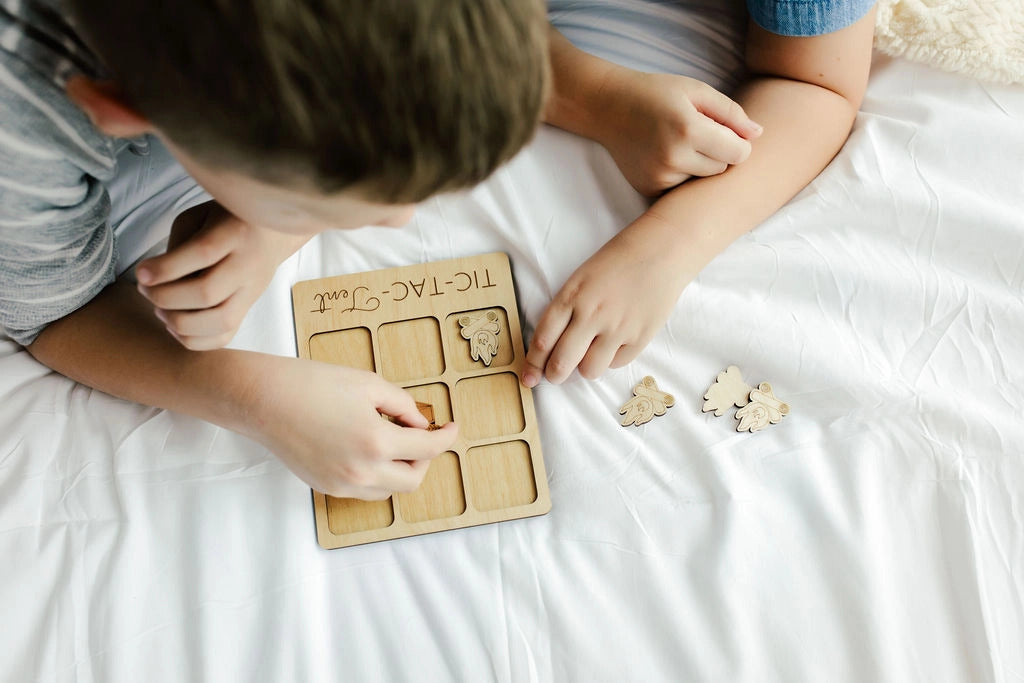 a young boy playing with a wooden puzzle