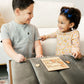 a boy and a girl playing a game on a coffee table