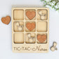 a wooden puzzle with a couple of rings and a heart