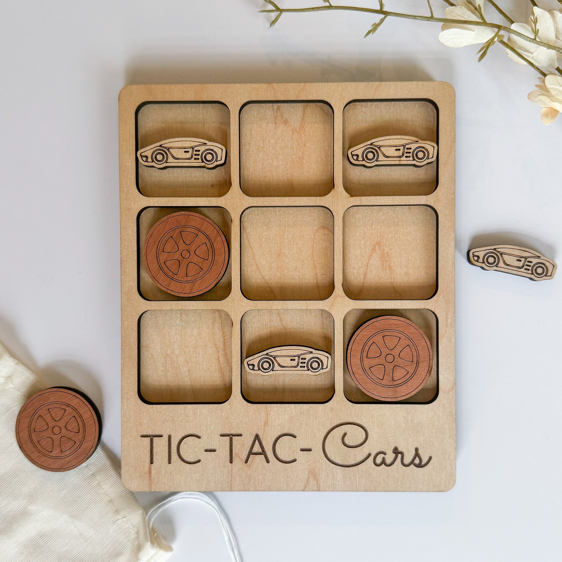 a wooden tic - tac - cars game with matching wooden pieces