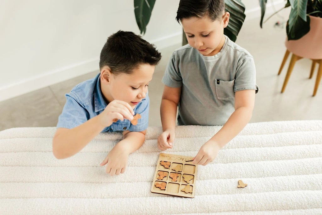 a boy and a boy playing with a puzzle