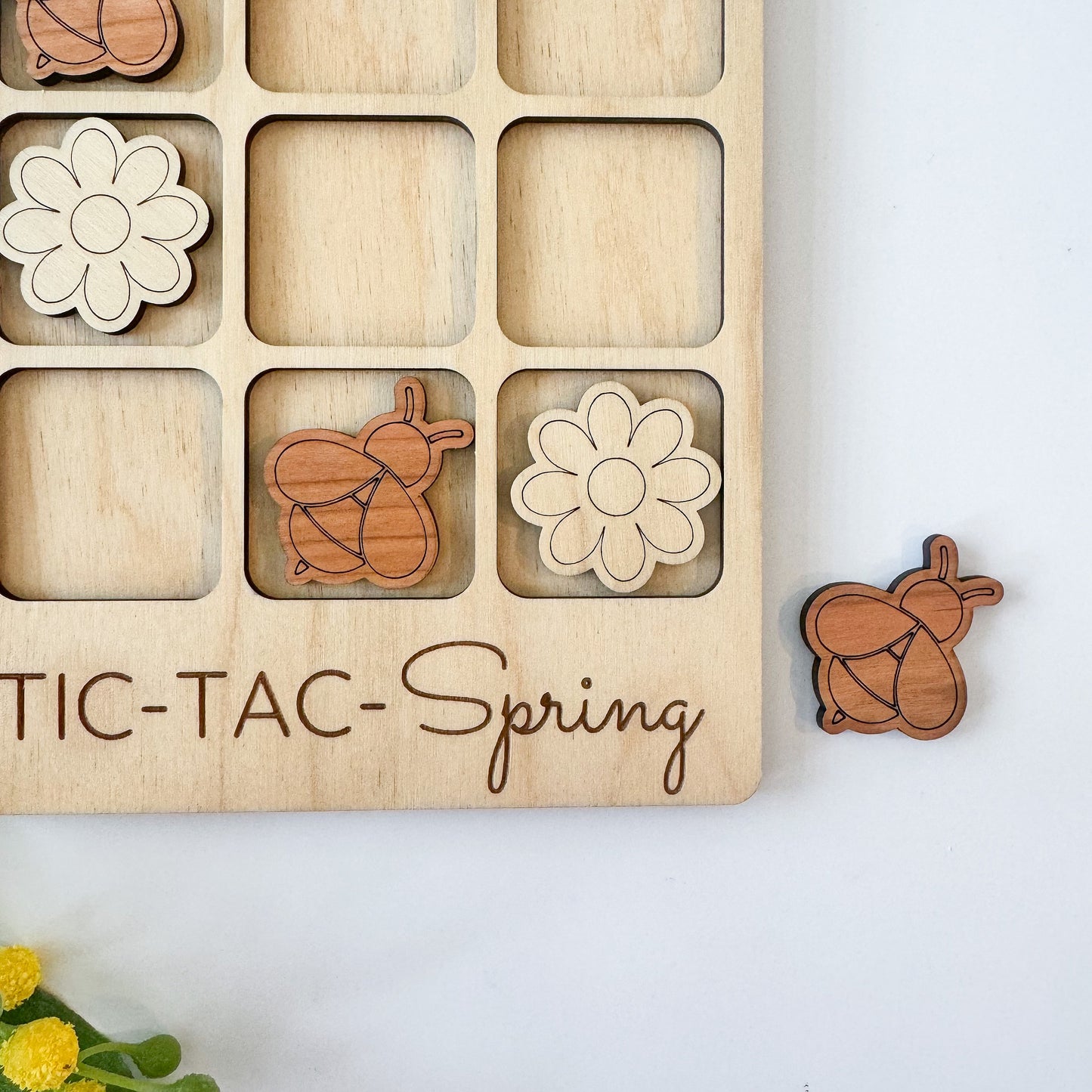 a wooden puzzle with a picture of flowers and a squirrel