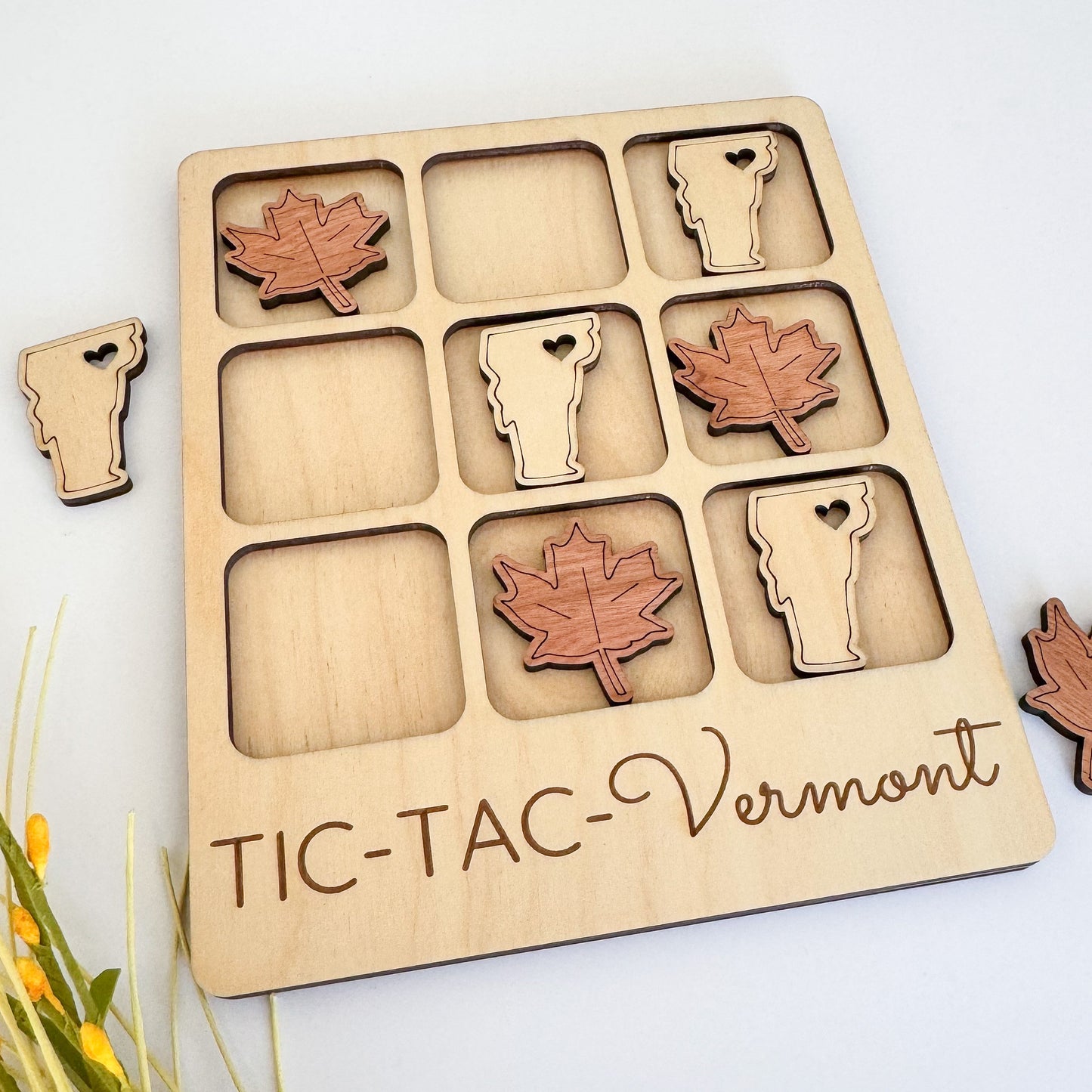 a wooden tray with wooden cutouts of different animals and leaves