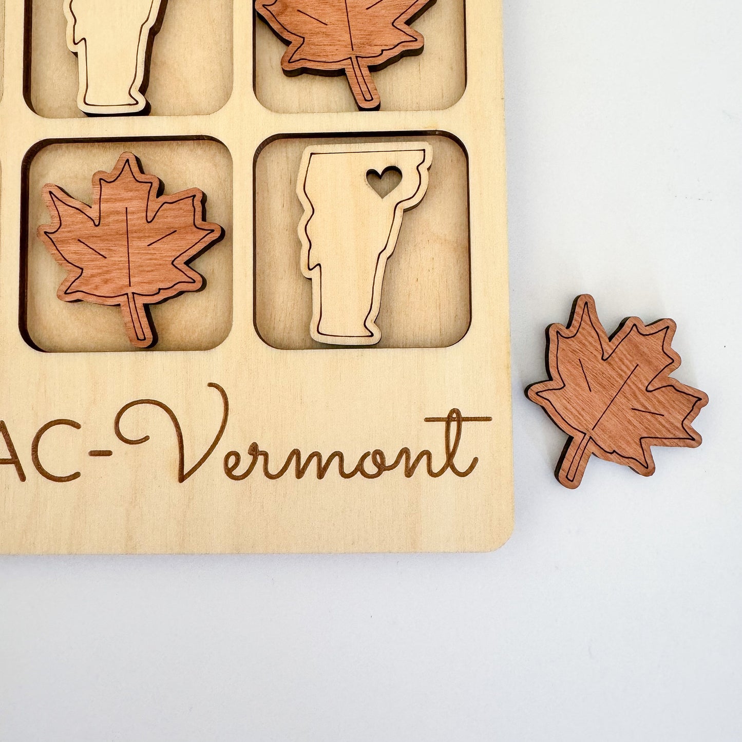 a wooden puzzle with a picture of a maple leaf, a glass of beer,