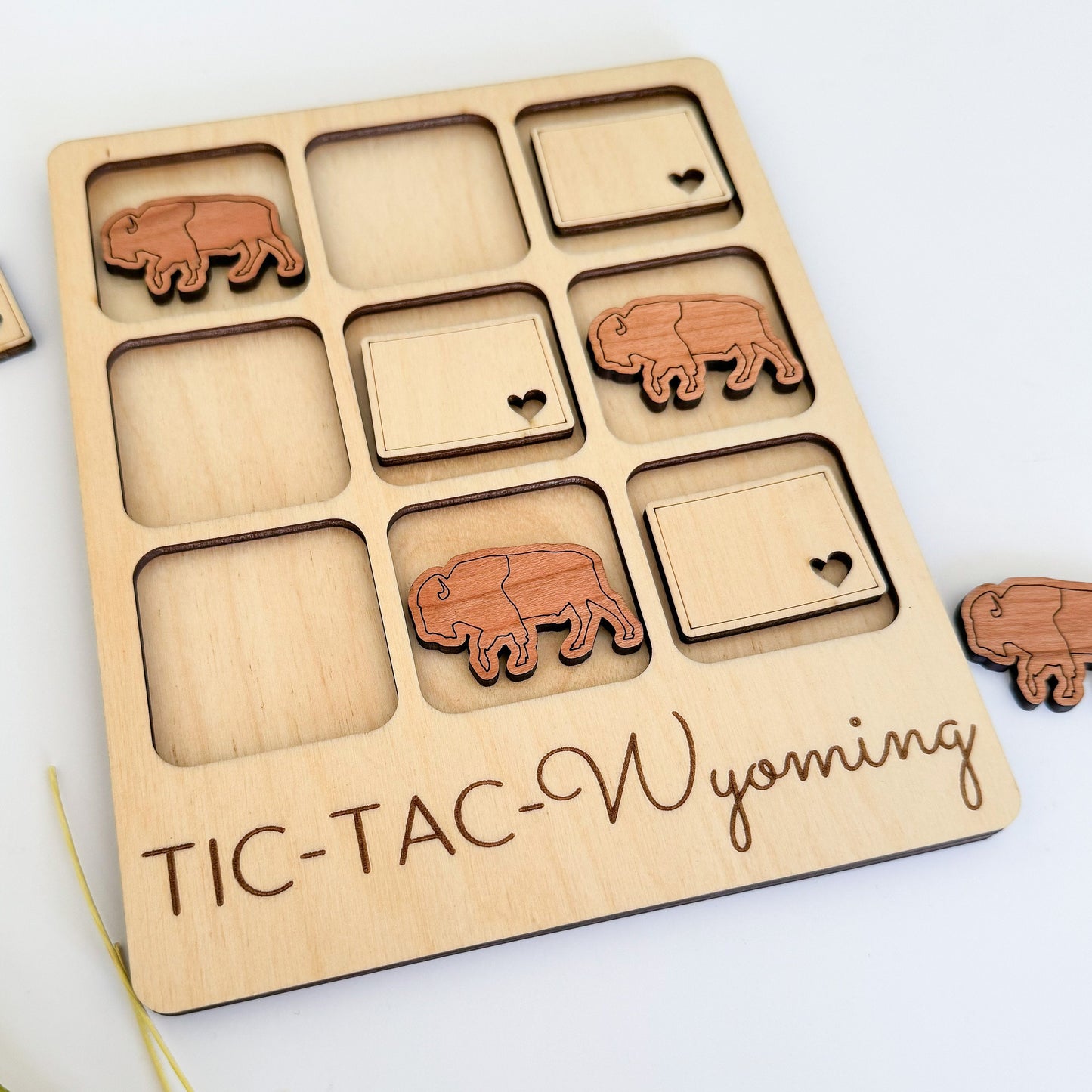 a wooden puzzle with elephants on it and the words tic - tac -