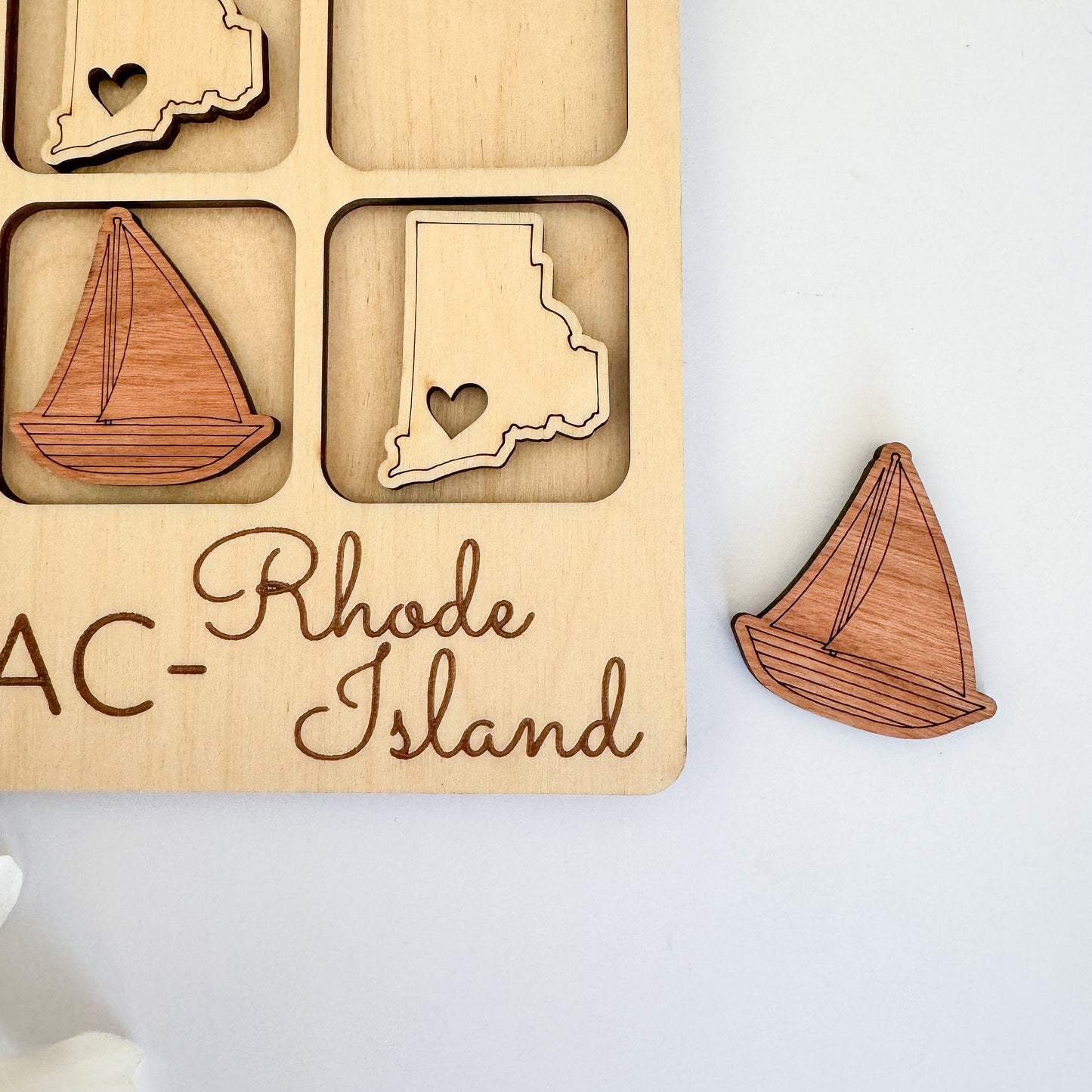 a wooden puzzle with a picture of rhode and a sailboat