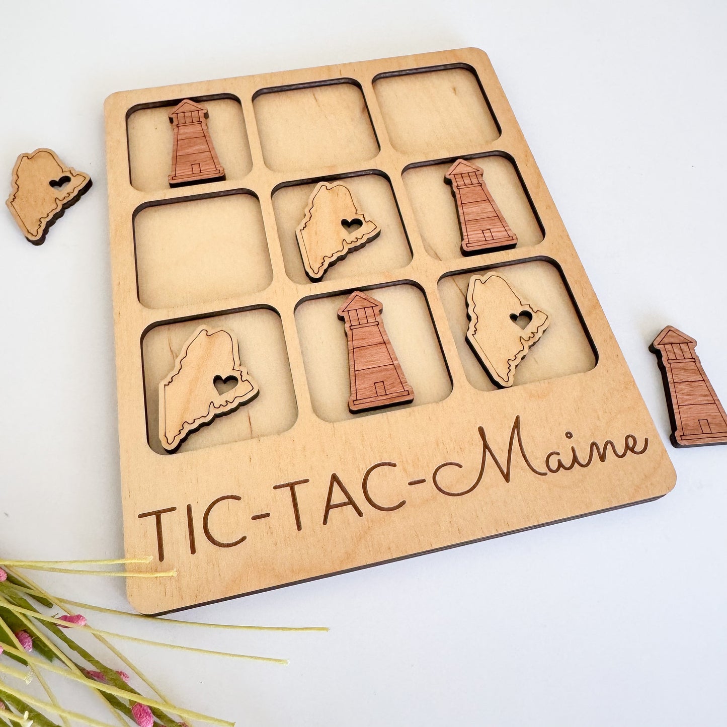 a wooden tic - tac - mania game with pieces cut out of it