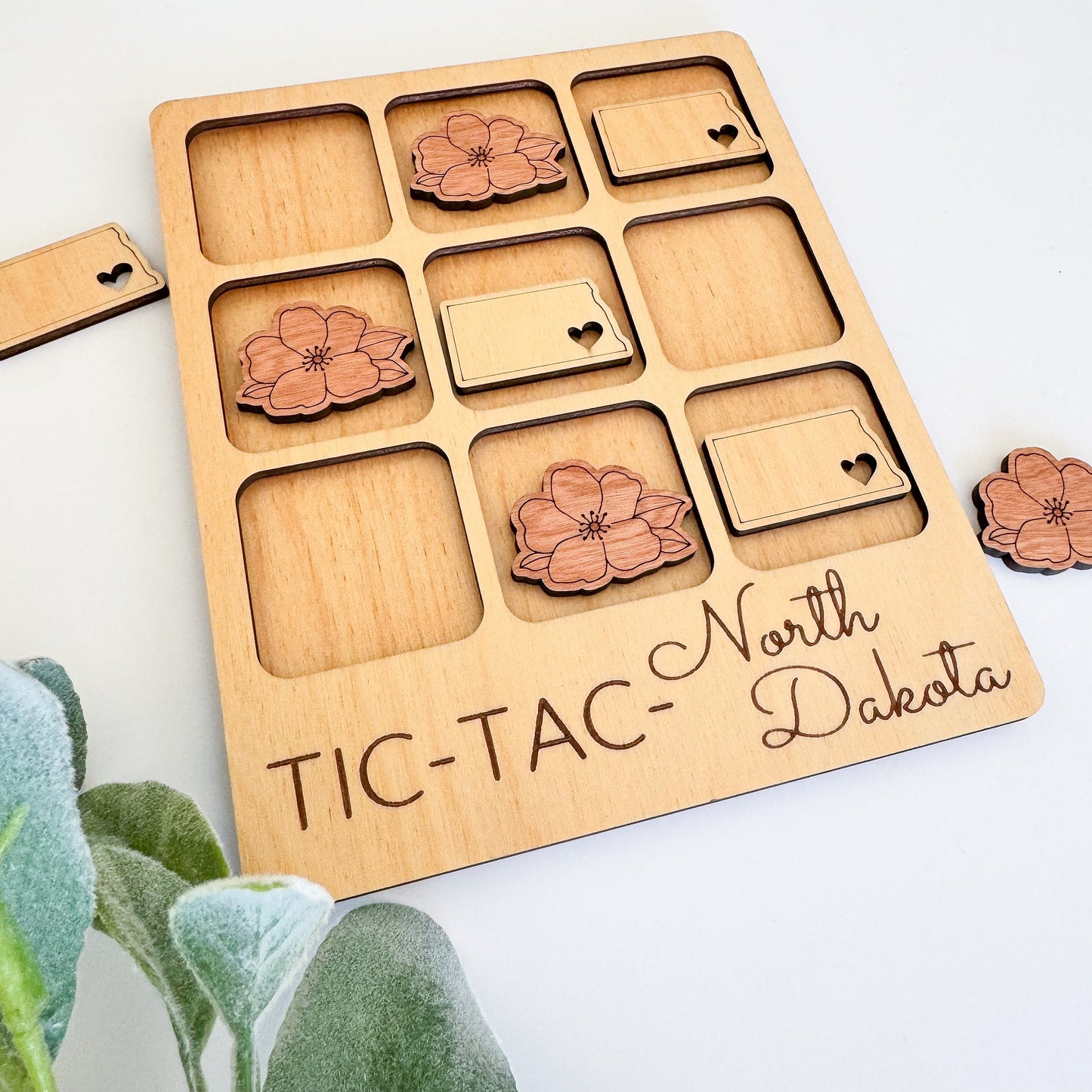 a wooden tic - tac - tac board with flowers on it