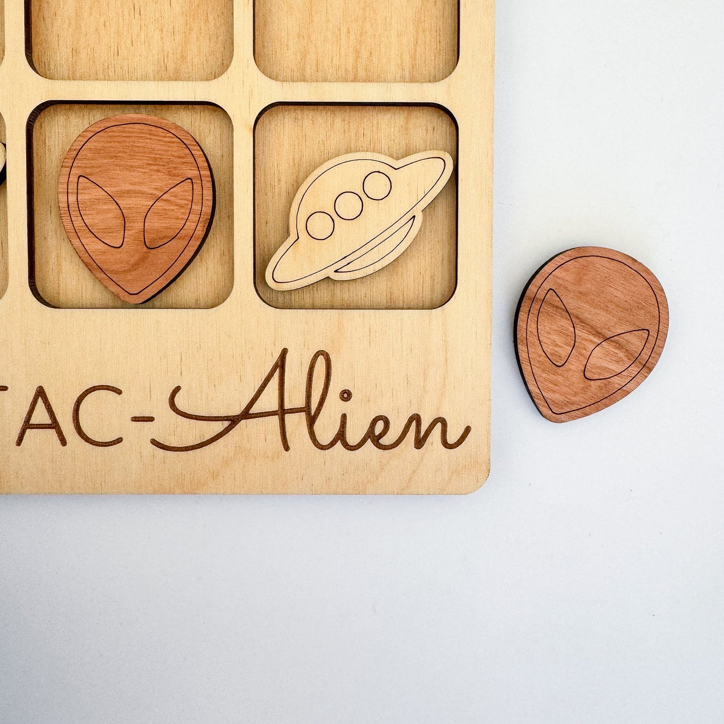 a wooden toy with magnets and a magnet board with a picture of an alien