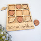 a wooden tic - tac - aiem game with wooden hearts and space