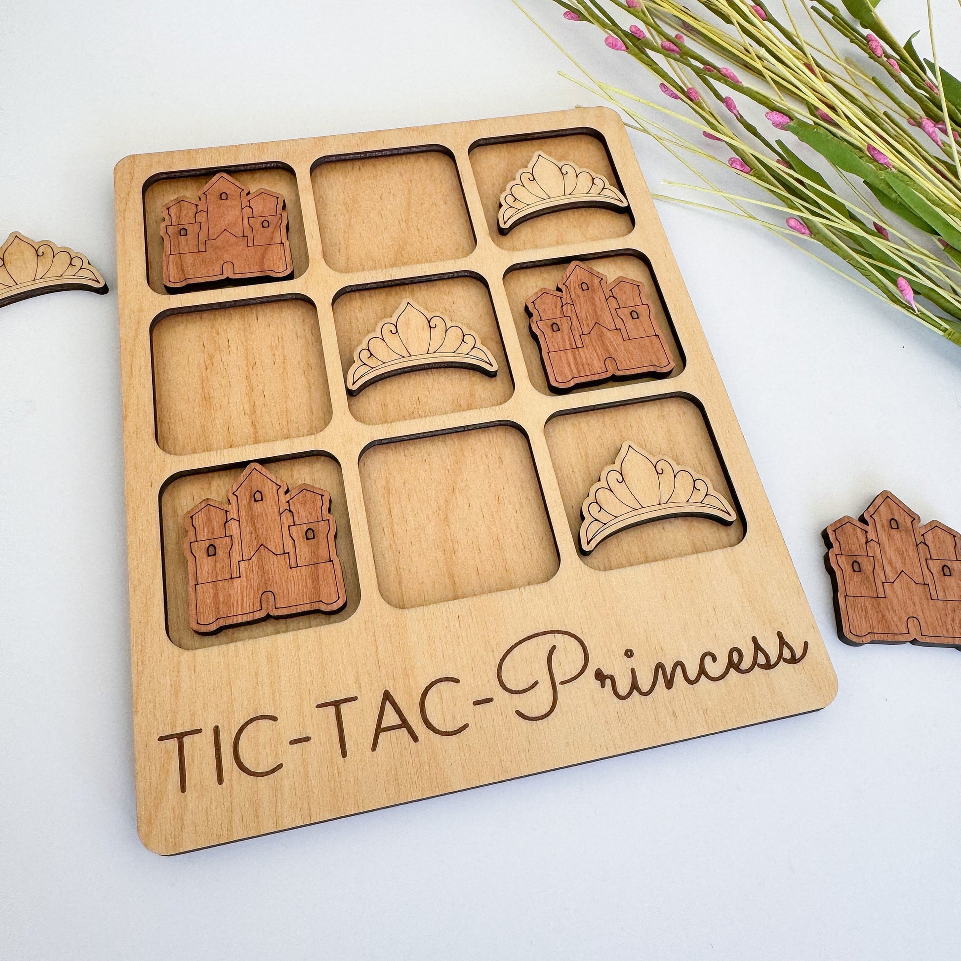 a wooden tic - tac - princess board game with pieces cut out of