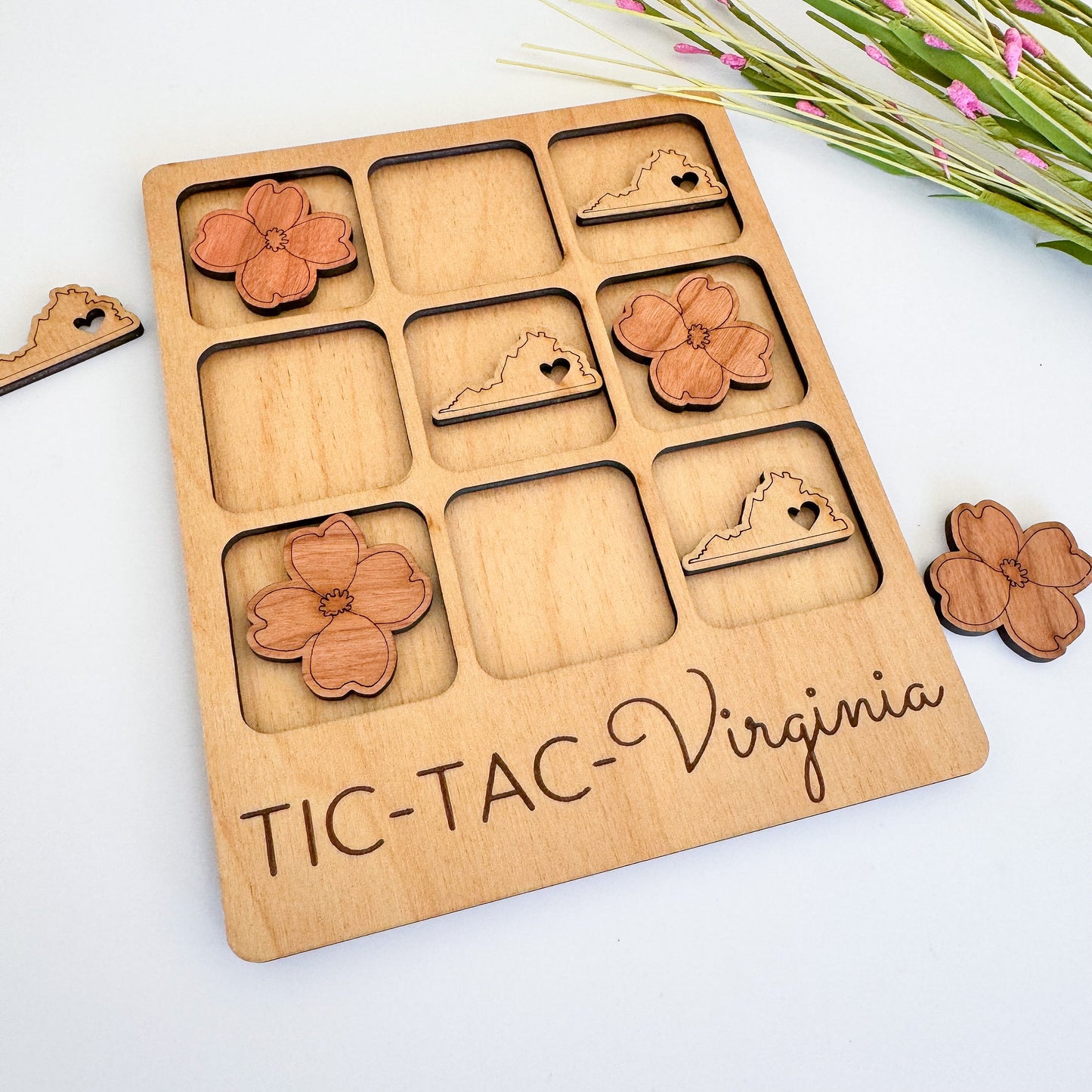 a wooden tic - tac - tac - virginia board game with a