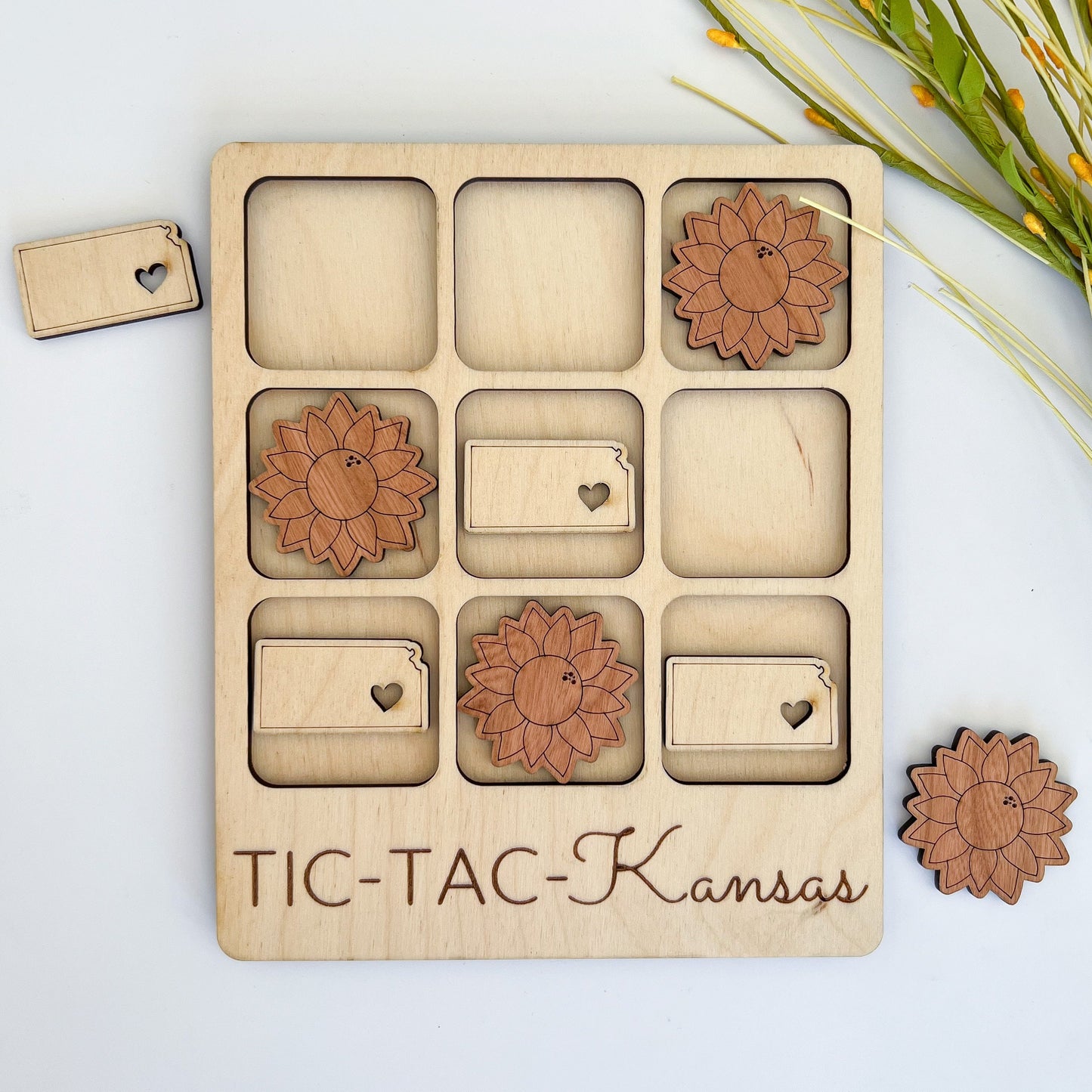 a wooden tic - tac - kansas game with flowers and hearts