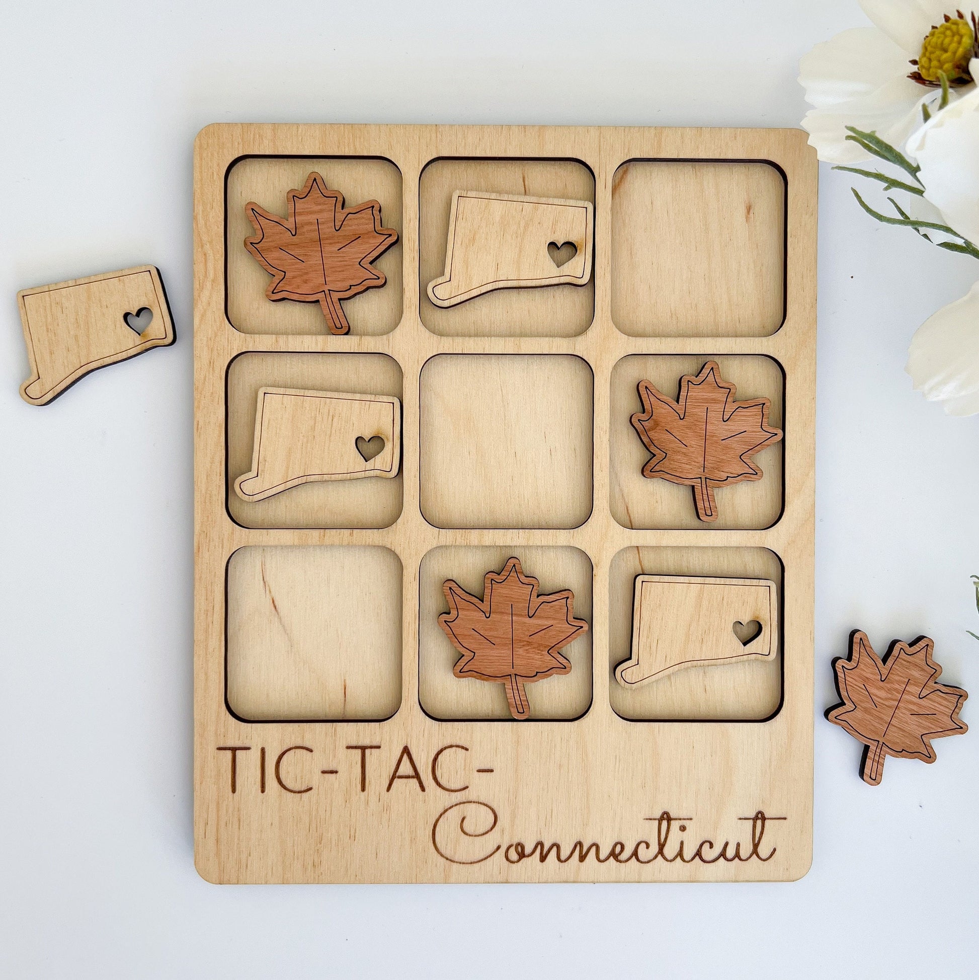 a wooden puzzle with a maple leaf and a piece of wood cut out of it