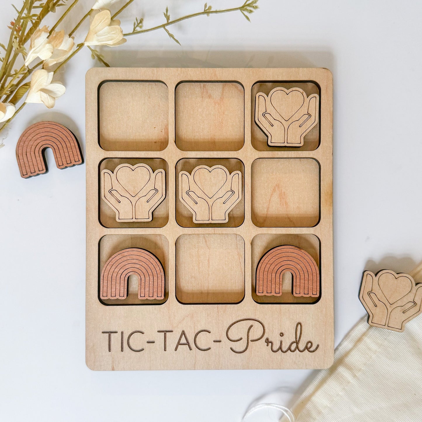 a wooden tic - tac - pride game with wooden pieces