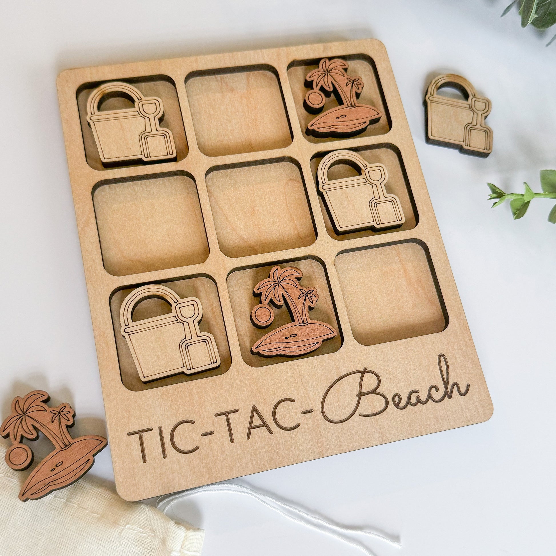 a wooden tic - tac - beach game set with a palm tree,