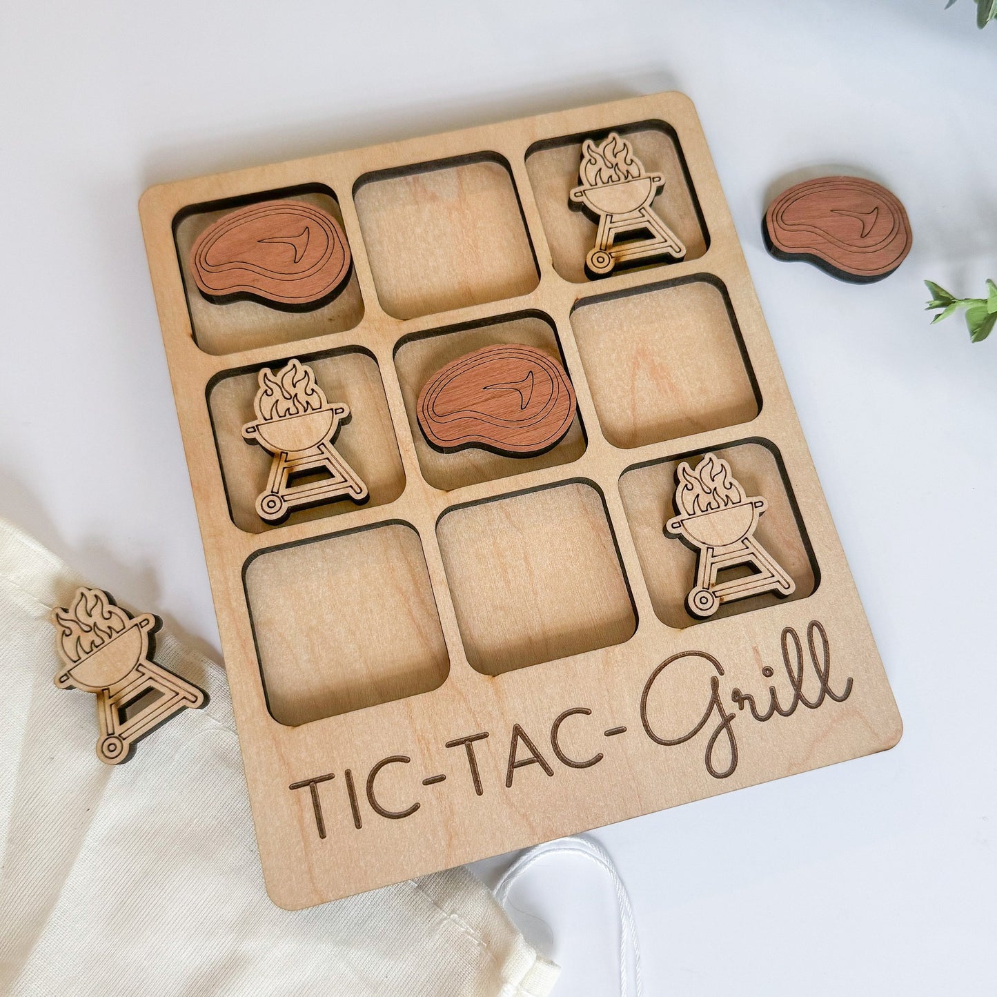 a wooden tic - tac - grill with wooden cutouts on a white