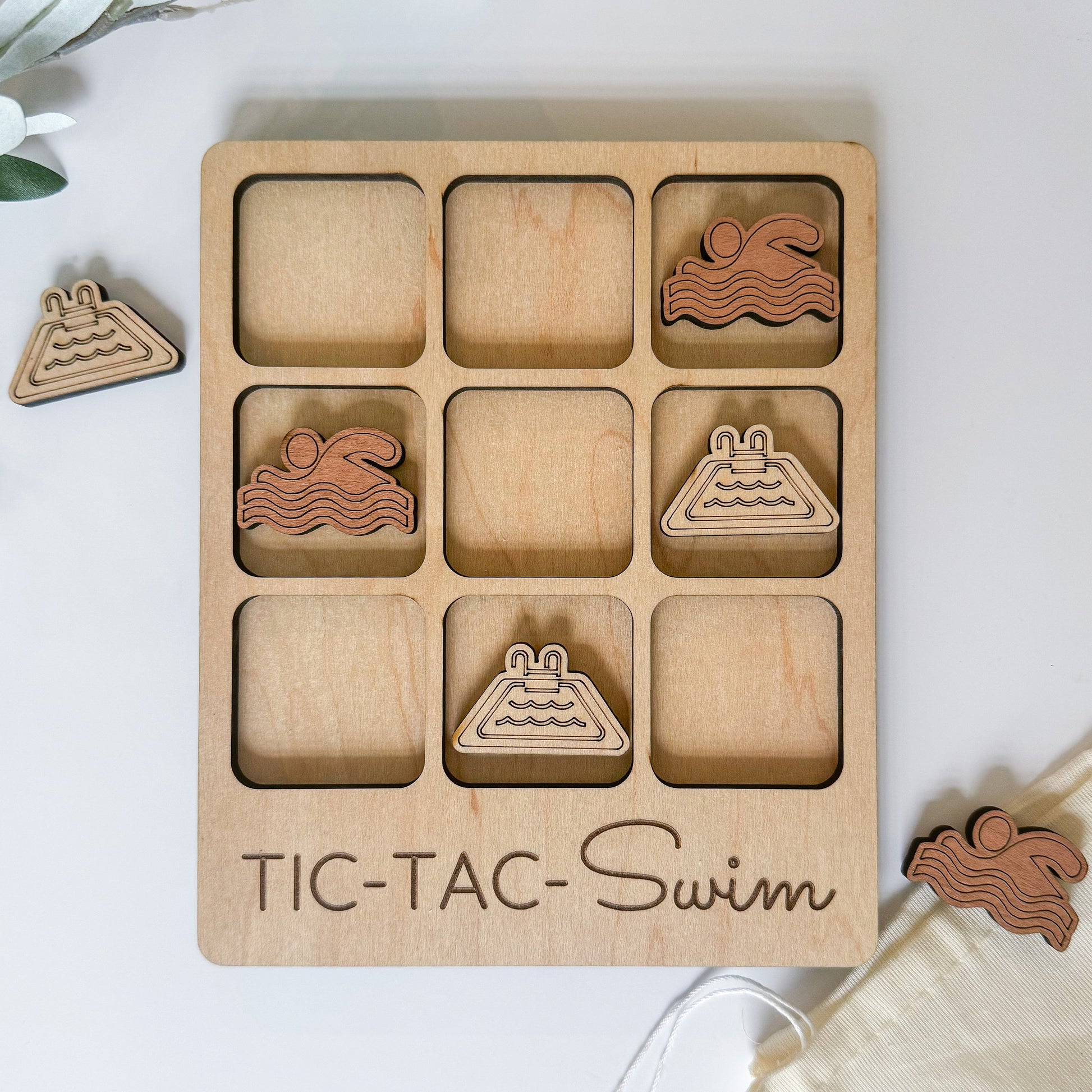 a wooden tic - tac - swim game with wooden pieces