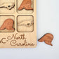 a wooden magnet with a picture of a bear and other magnets