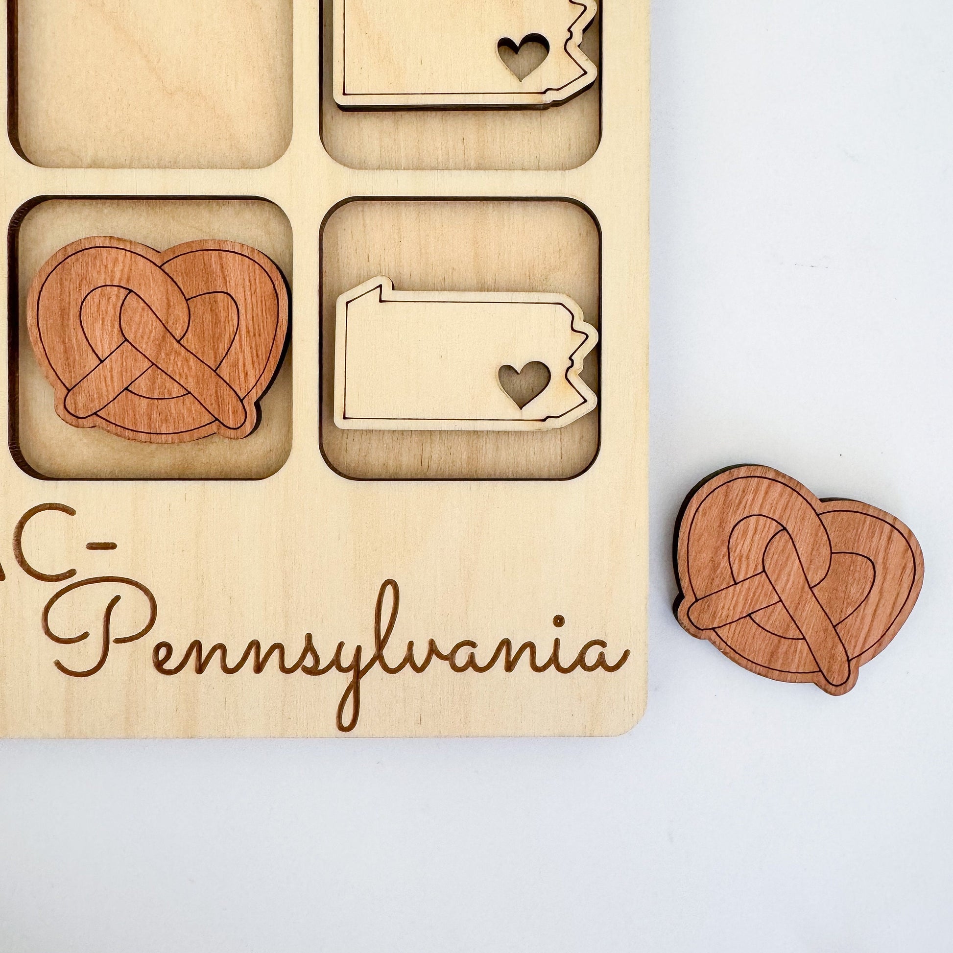 a wooden puzzle with a couple of hearts