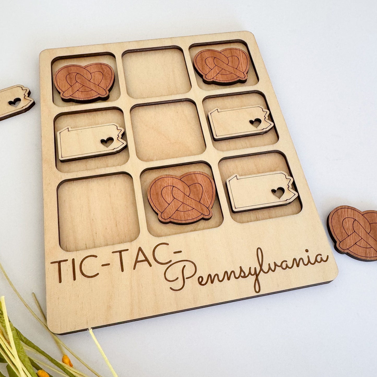 a picture of a wooden tic tac - tac game