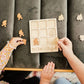 two children are playing with a wooden puzzle