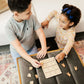 a boy and a girl playing with a puzzle