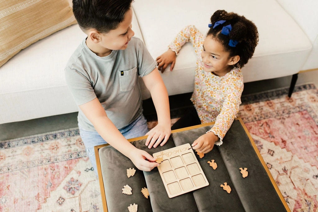 a boy and a girl playing with a puzzle