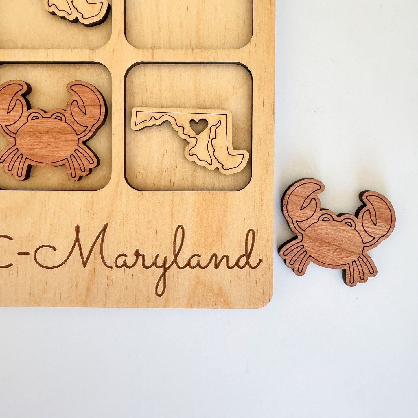 a wooden puzzle with a picture of a crab and a map of the state of