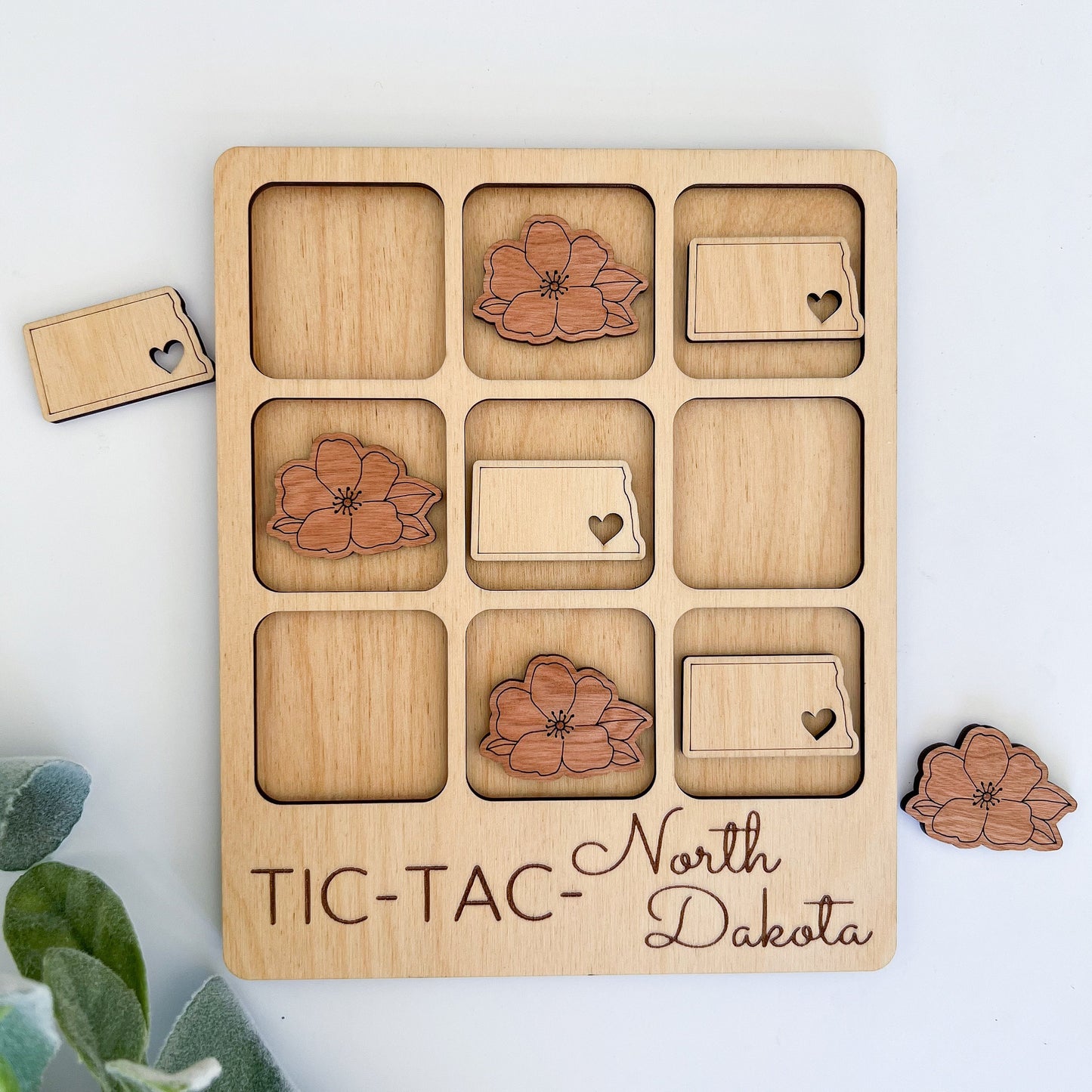 a wooden tic - tac - tac with flowers on it