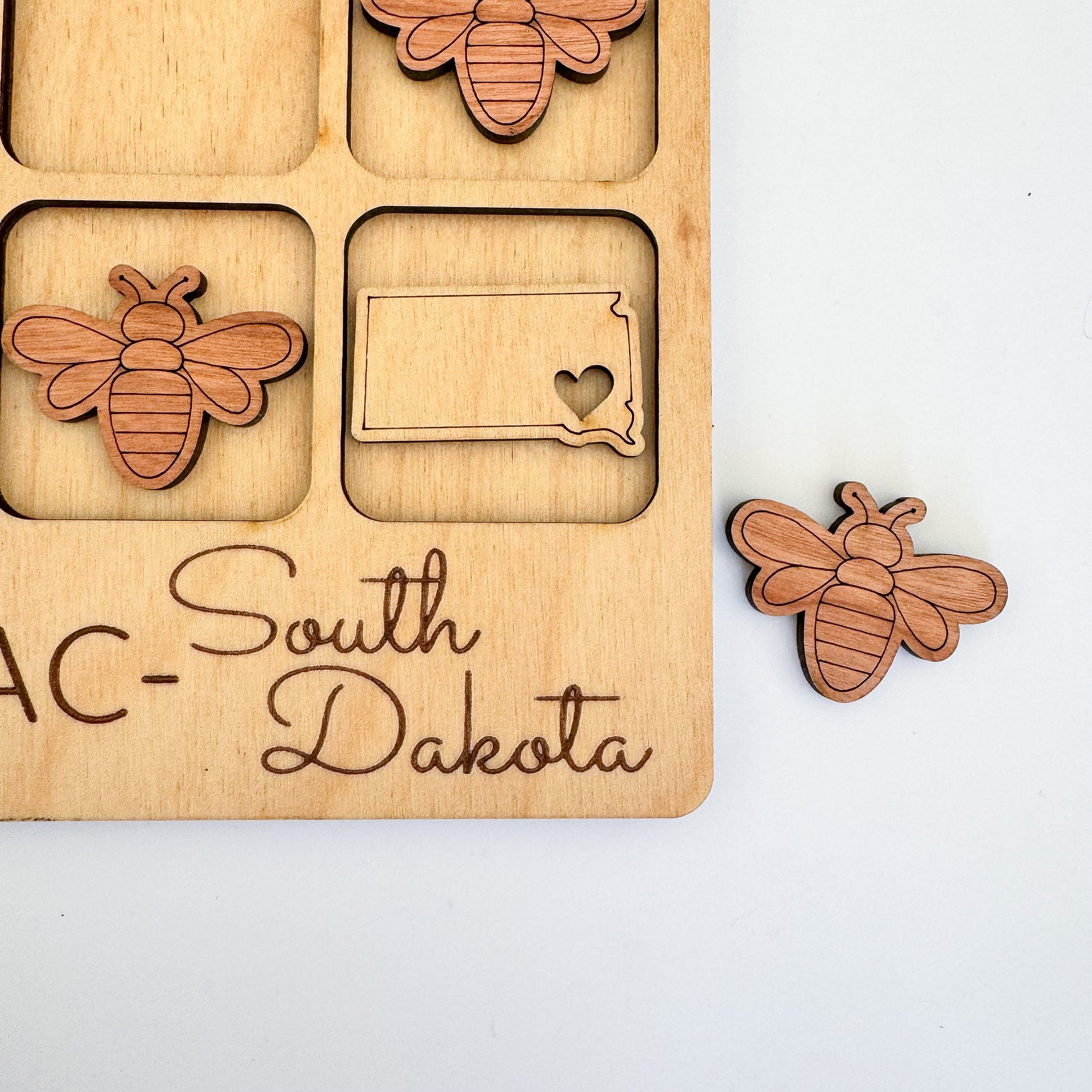 a wooden puzzle with a picture of a couple of bees