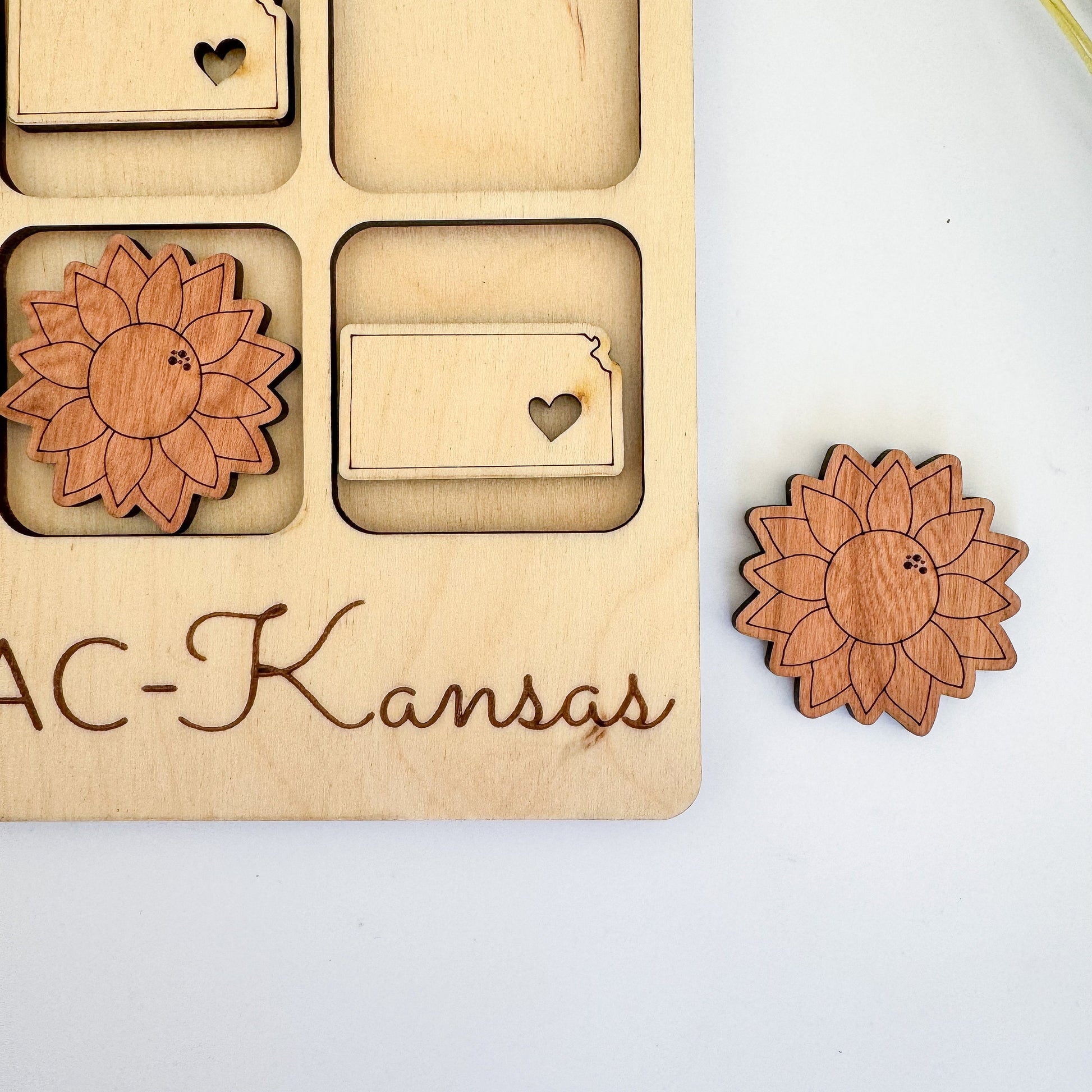 a wooden puzzle with a flower and a name on it