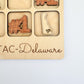 a wooden plaque with the words tac - delaware on it