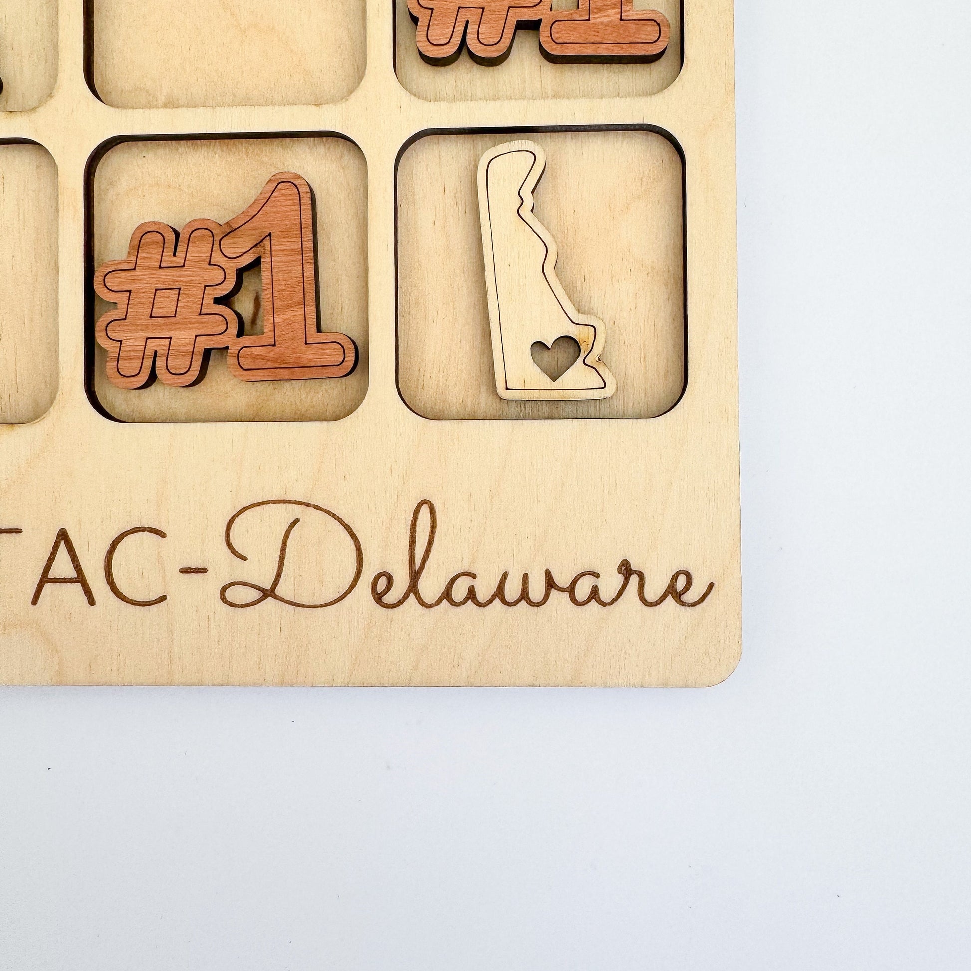 a wooden plaque with the words tac - delaware on it