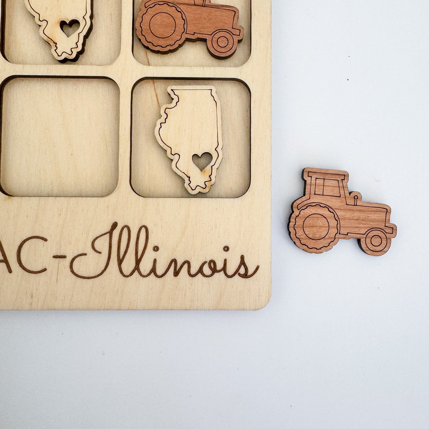 a wooden puzzle with a picture of a tractor and a heart