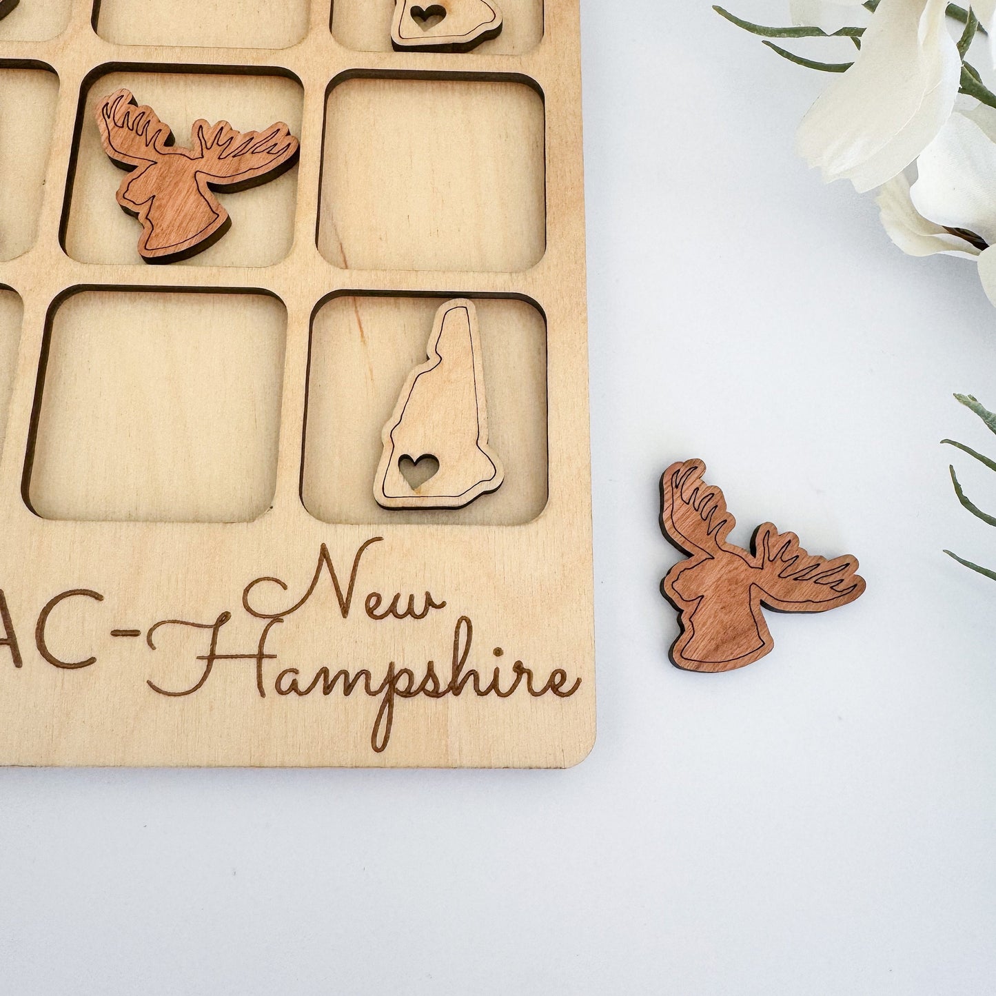 a wooden puzzle with a picture of the state of ac - new hampshire