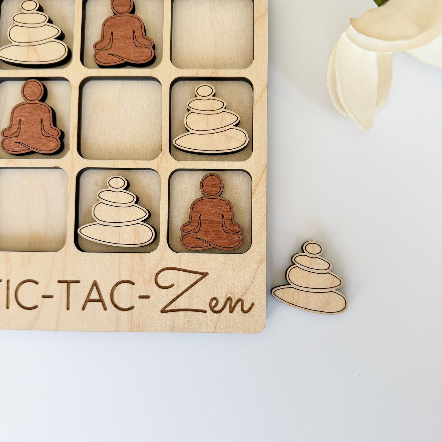 a wooden puzzle with a picture of a person sitting in a lotus position