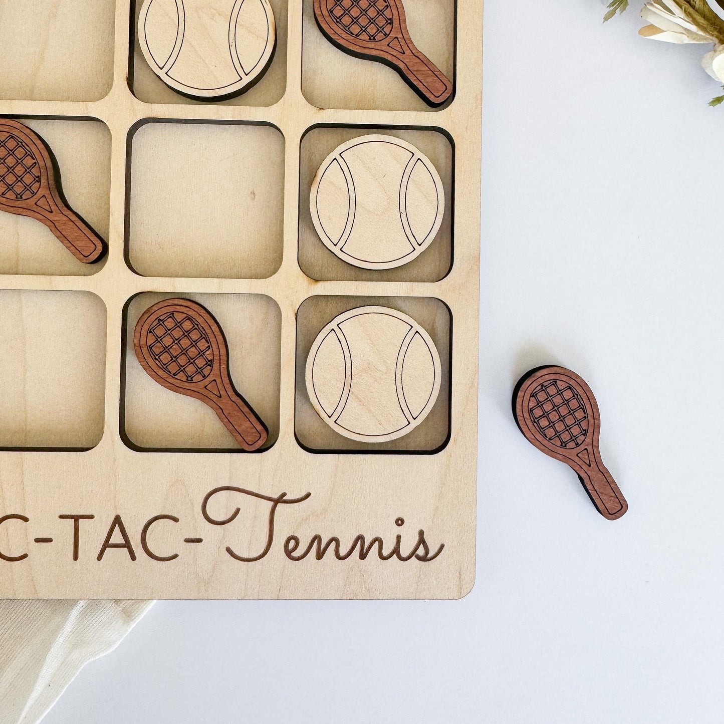 a close up of a wooden tray with tennis balls and rackets