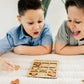 two young boys playing with a wooden puzzle