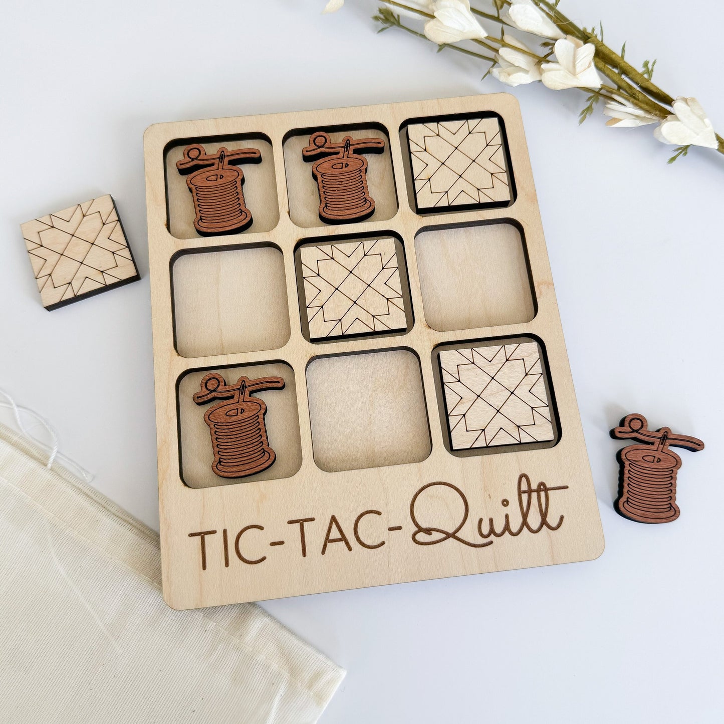 a wooden tictac - quilt box with a few pieces of it