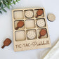 a wooden tic - tac - pokeball game with wooden paddles and