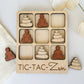 a wooden tic - tac - zn game with a white tulip