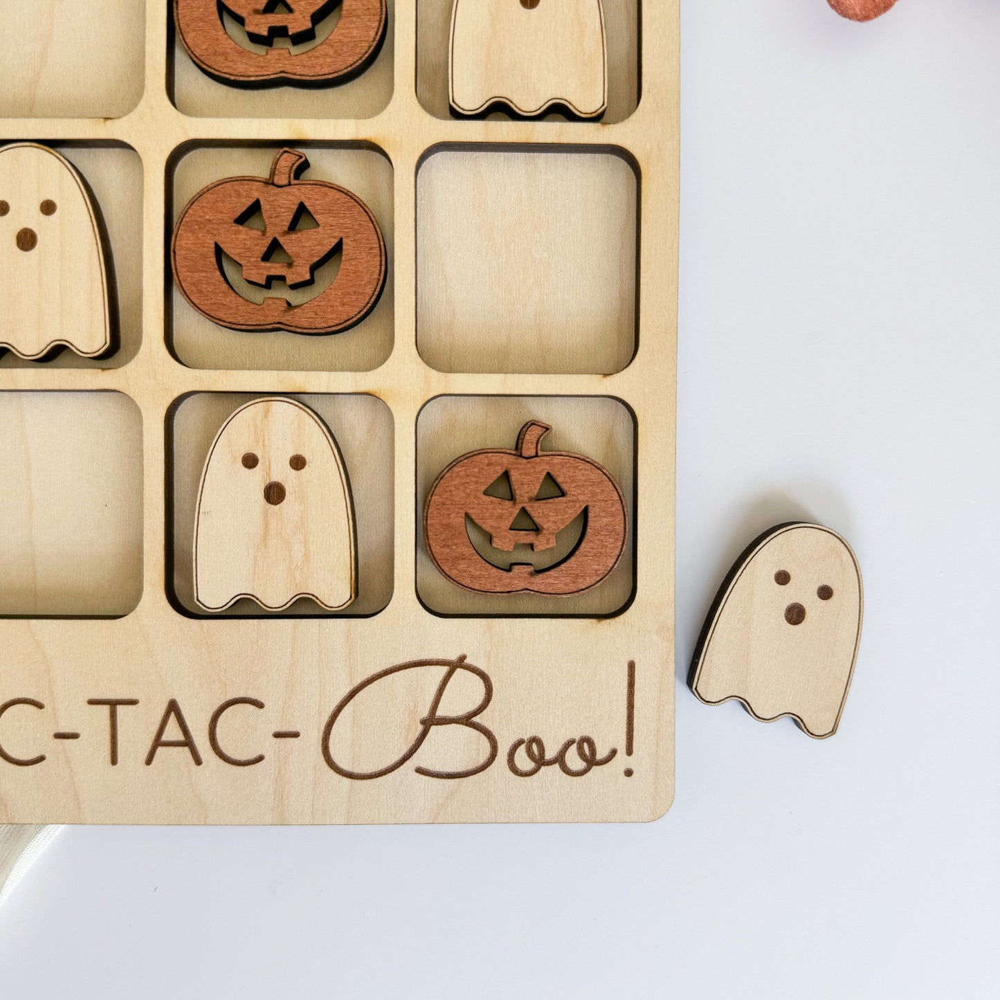 a wooden puzzle with carved pumpkins and ghost faces