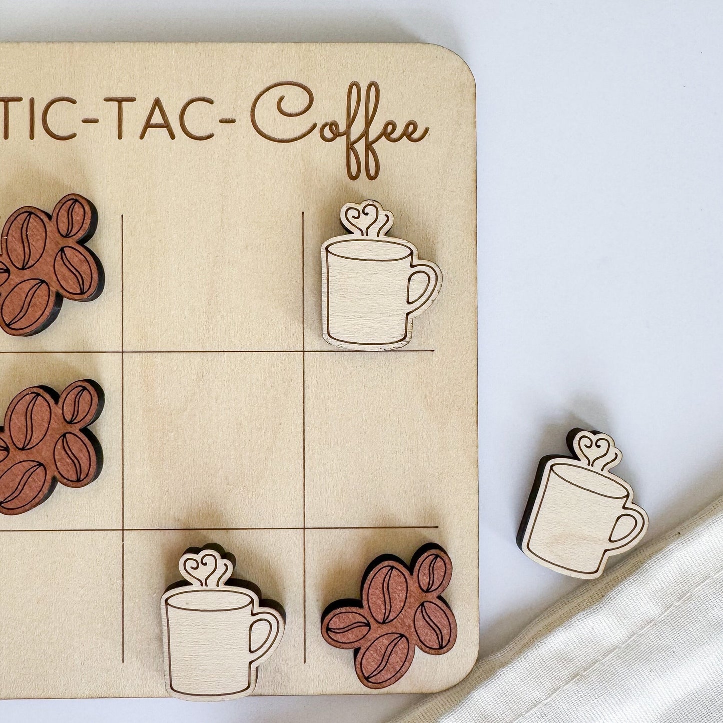 a wooden board with coffee themed magnets on it