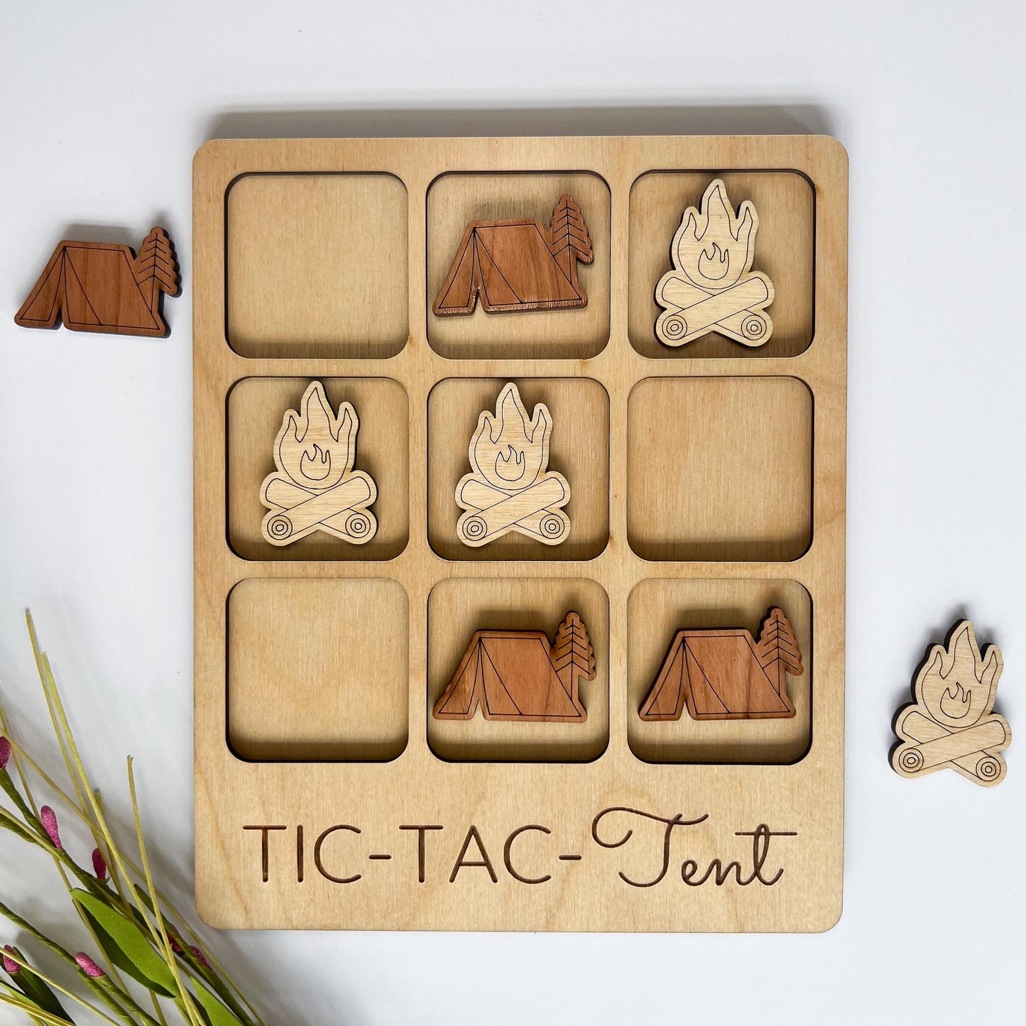 a wooden tic - tac - tac game with wooden cutouts of